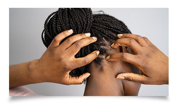 woman-smiling-while-fixing-her-curly-hair-on-orange-background-healthy-scalp-concept