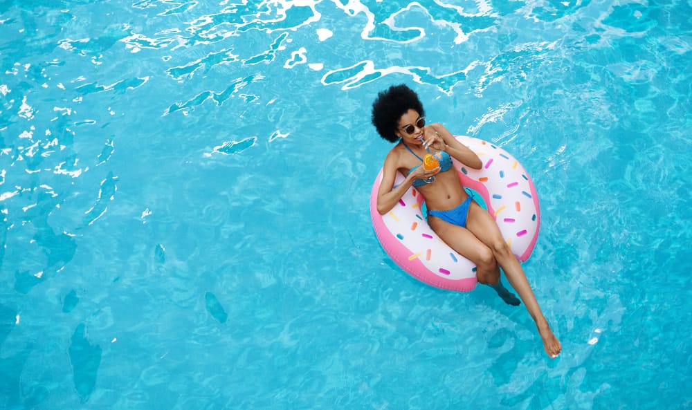 Woman in pool | summer hair care RevAir