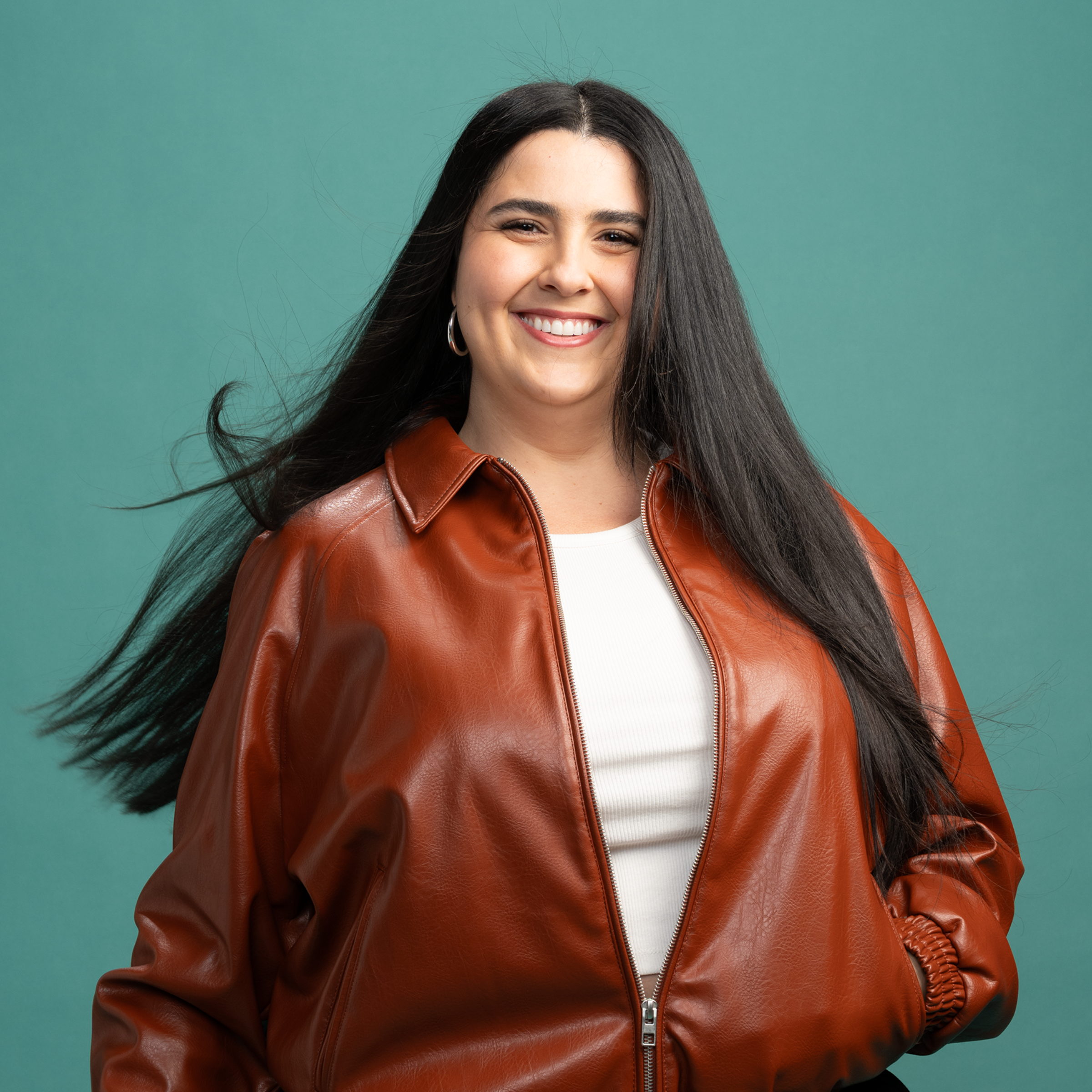 Woman with long, straight dark hair smiling at camera after using RevAir