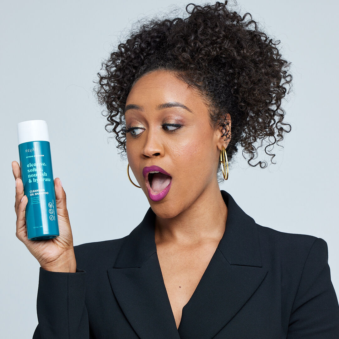 woman looking surprised and amazed at RevAir extreme hydration cleansing oil shampoo - cleanse, soften, nourish, and hydrate