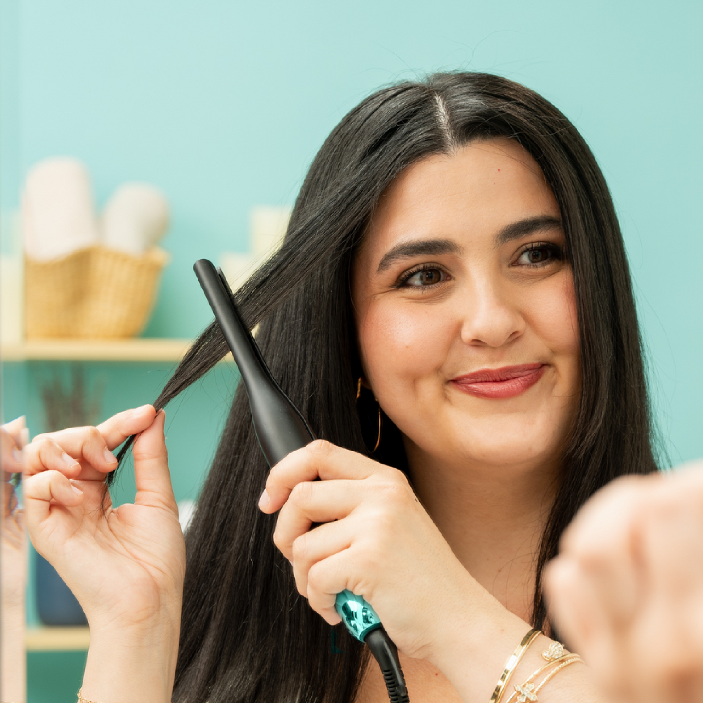 Woman using the RevAir Micro Edge Styler precision flat iron to smooth hair, ideal for straightening roots, bangs, and flyaways.