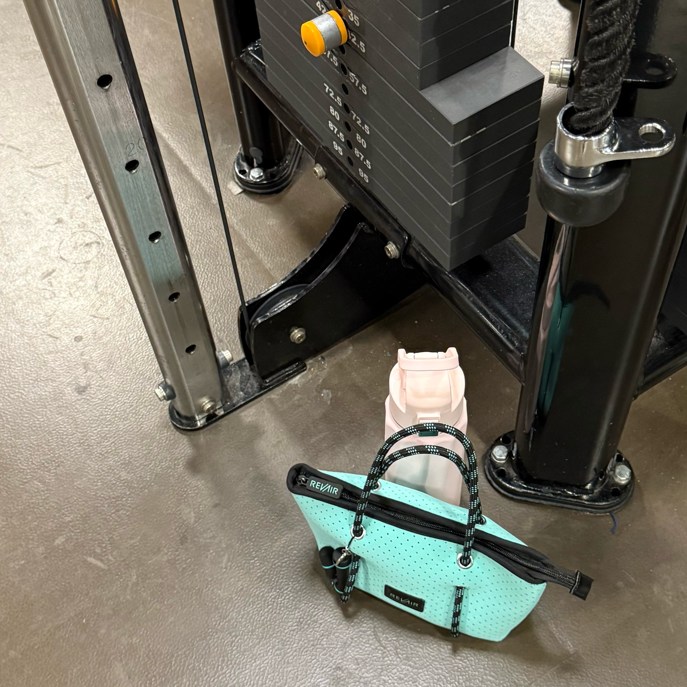 Sidekick tote bag at gym next to water bottle and weights machine