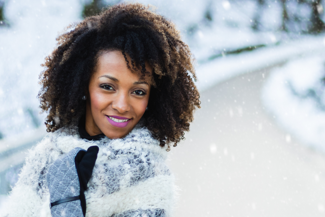 African American Woman with Curly Hair in Snow