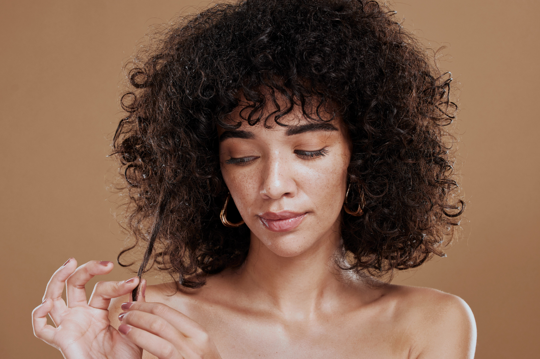 Mixed Race Woman Examining Her Hair for Damage