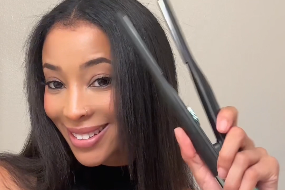 Woman holding the RevAir Micro Edge Styler next to smooth, straight hair, demonstrating precision styling for sleek finishes.
