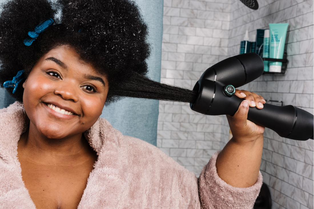 African American woman stretching her natural hair with the RevAir Reverse-Air Dryer