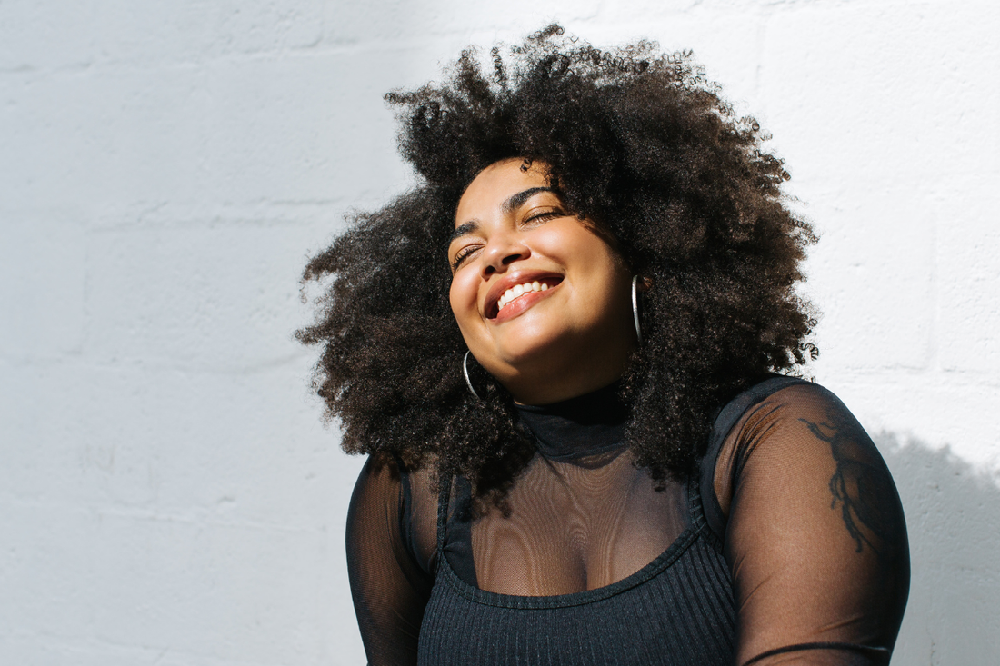 Natural curls worn confidently as part of a healthy hair care journey