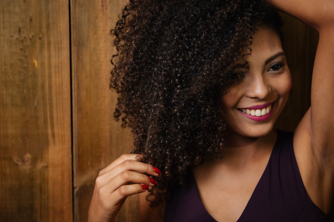 Defined, hydrated curly hair showing moisture retention and softness