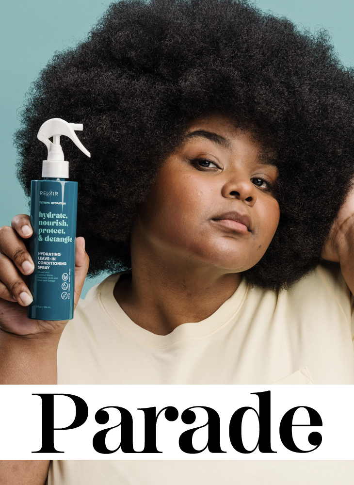 A Black woman with a large natural afro holding a bottle of RevAir Extreme Hydration Hydrating Leave-In Conditioning Spray against a teal background, with the Parade logo displayed below