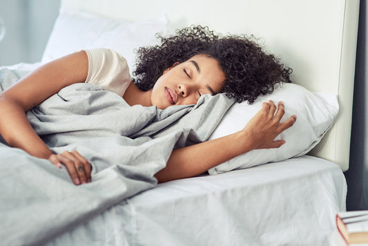 young-woman-with-wet-hair-sleeping-peacefully-in-her-bed