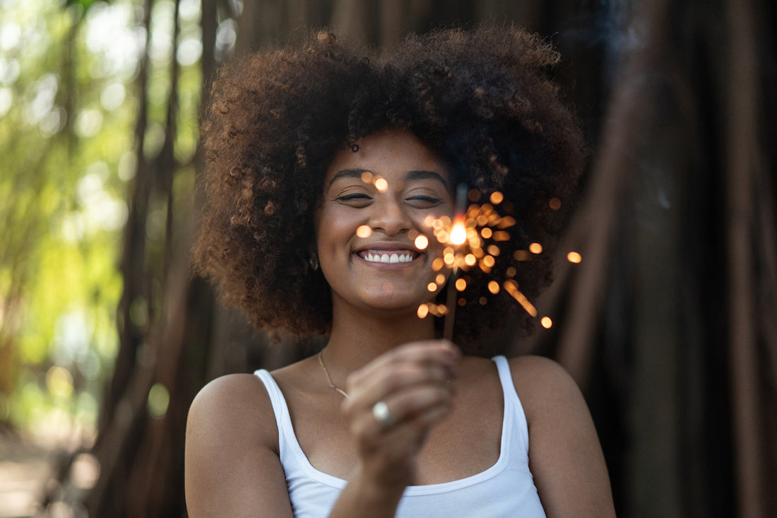 curly-hair-woman-burning-sparklers-new-year-concept