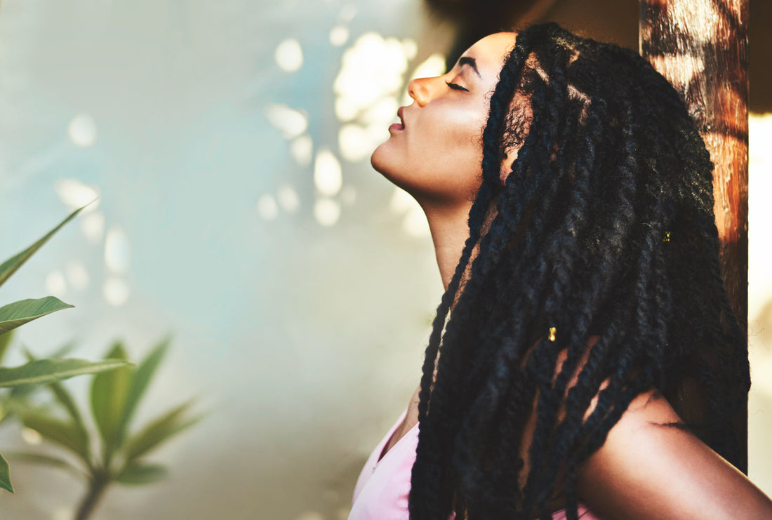 young-woman-with-soft-locs-protective-hairstyles-posing-in-nature