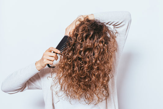 woman-brushing-her-curly-hair