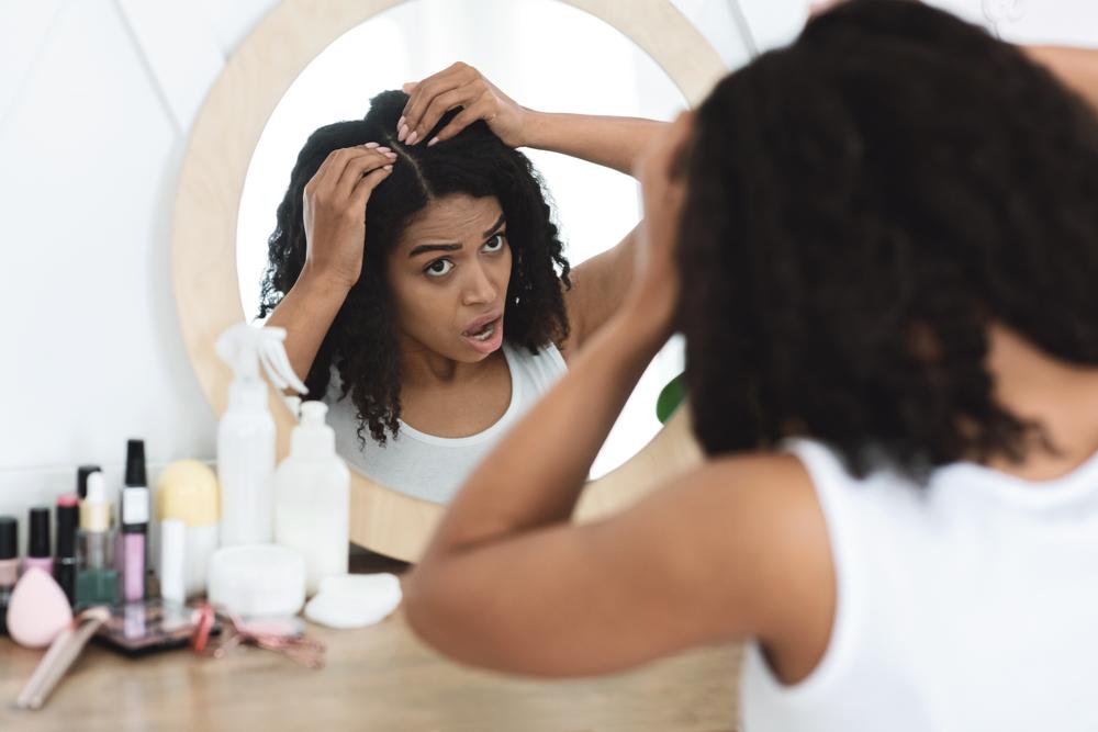 woman-with-curly-hair-having-dry-scalp