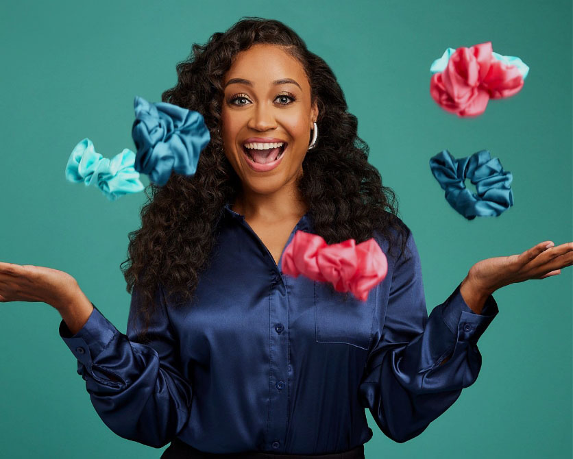 Woman smiling as scrunchies fall into her outstretched hands