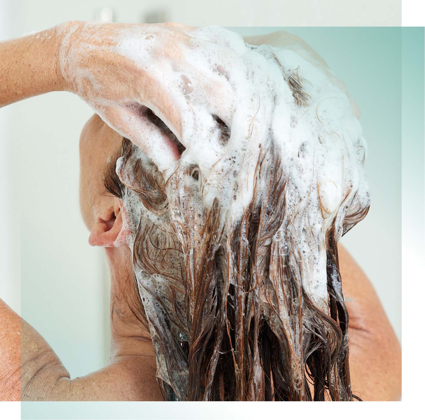 Woman shampooing hair in the shower