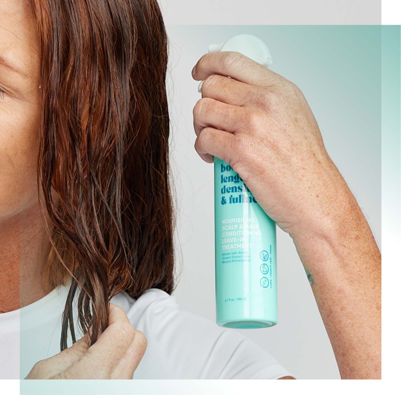Woman spraying conditioning leave-in treatment on her wet hair