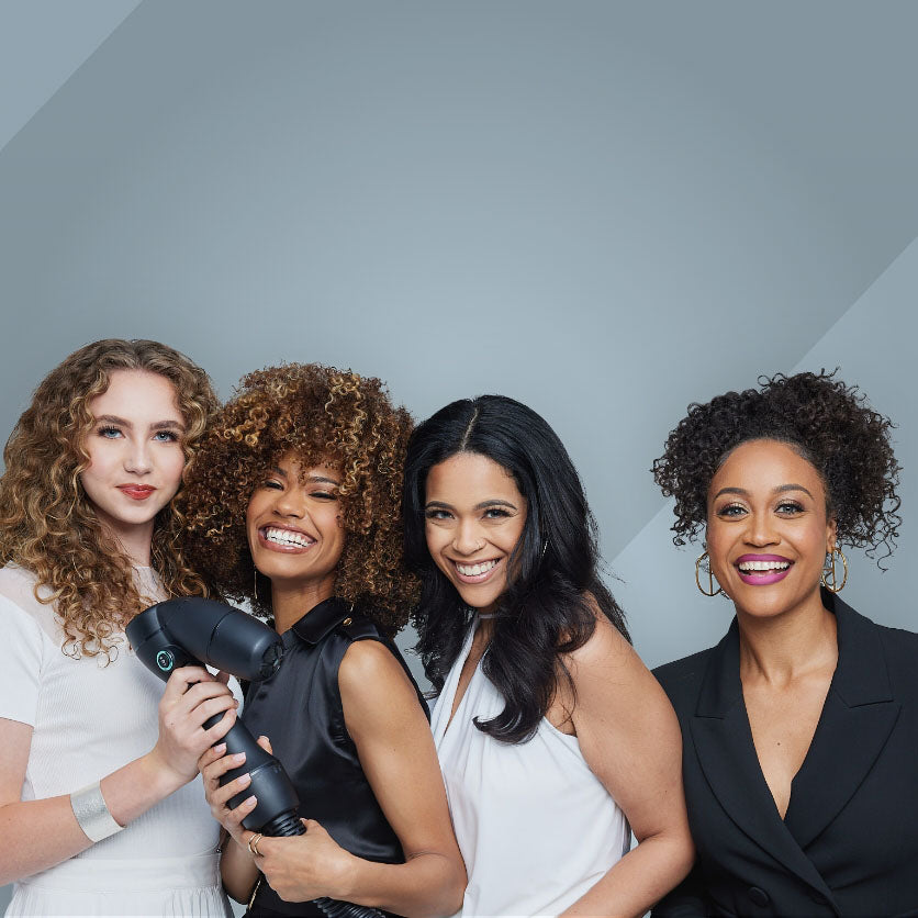 Diverse group of women holding the RevAir wand and smiling
