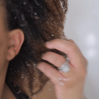 Washing coily hair with oil cleansing shampoo, hydrating suds