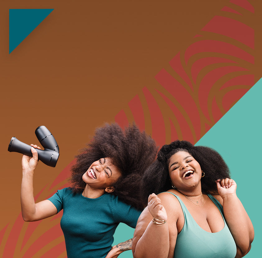 Two women with styled hair laughing and dancing while one holds a RevAir wand