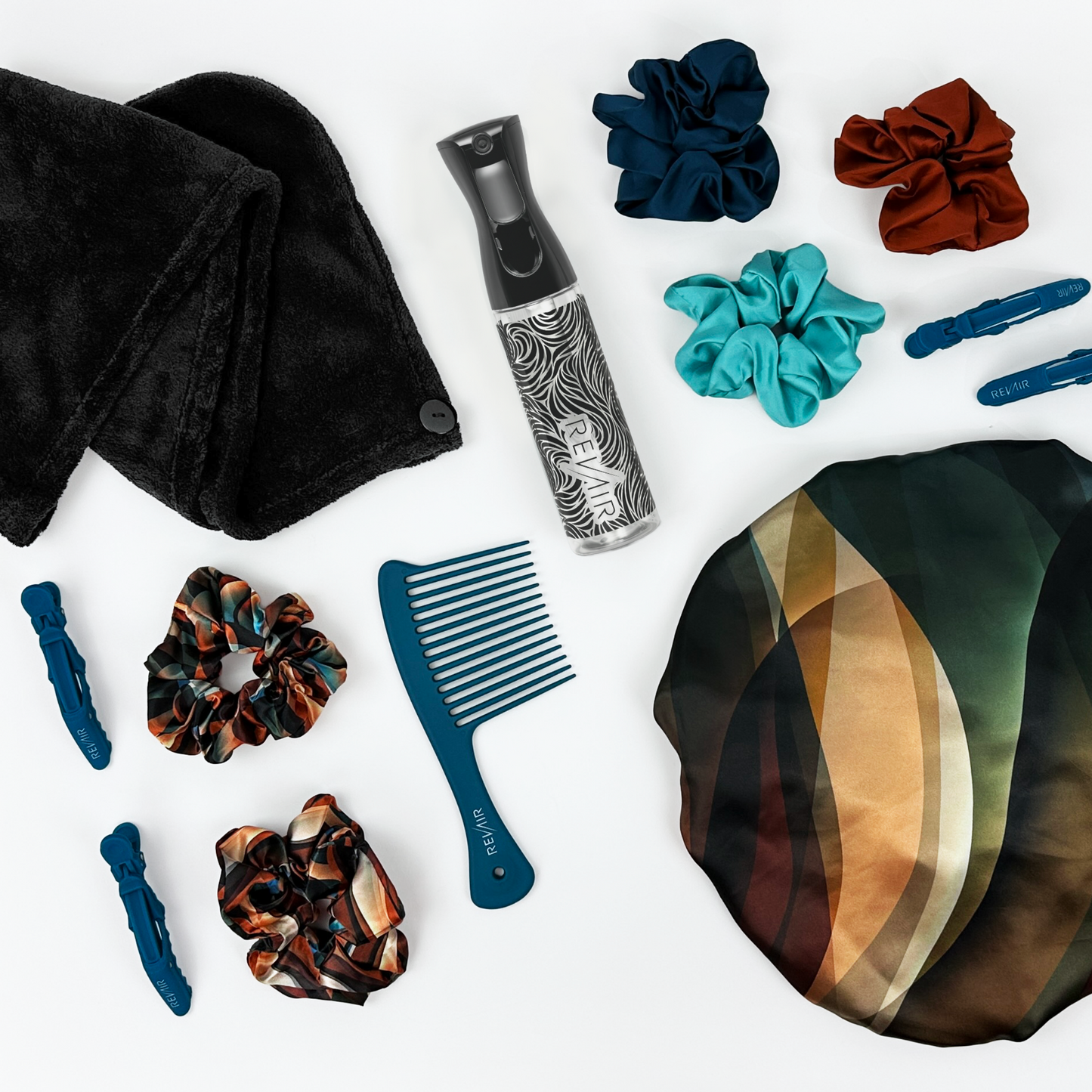 Collection of RevAir brand hair care products including scrunchies, a comb, and a towel on a white background