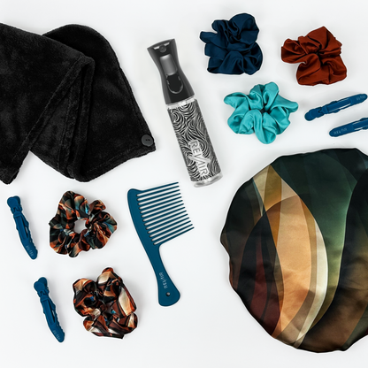 Collection of RevAir brand hair care products including scrunchies, a comb, and a towel on a white background