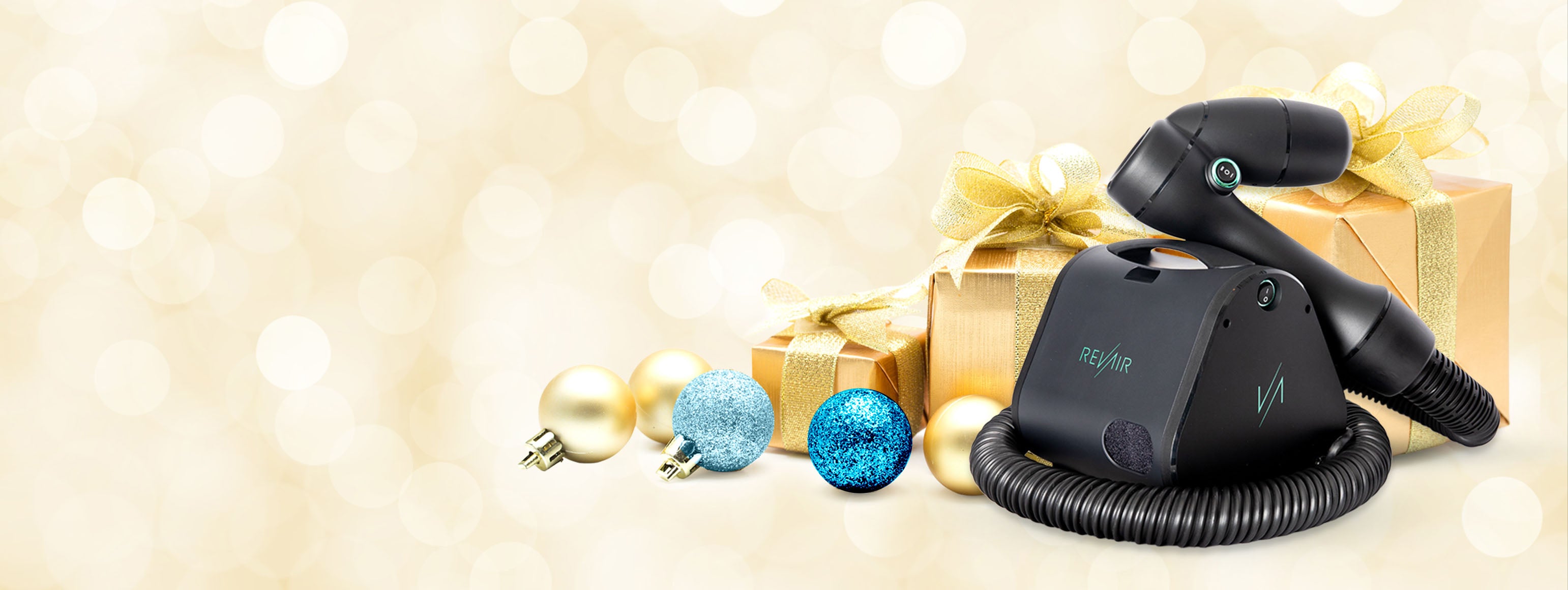 RevAir hair dryer with a gold gift box and holiday ornaments