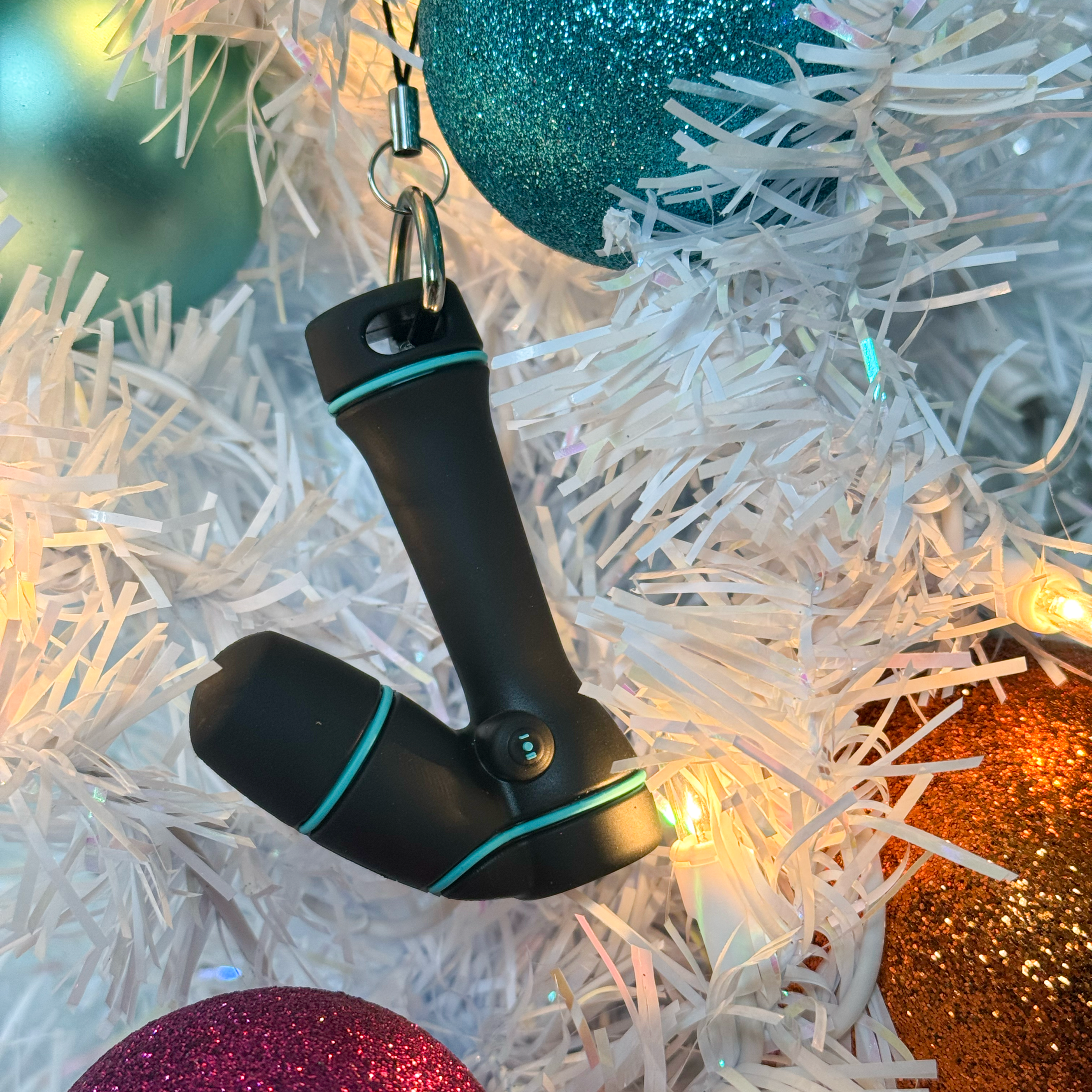 Mini wand bag charm shown hanging as an ornament from a white Christmas tree with colorful ornament globes