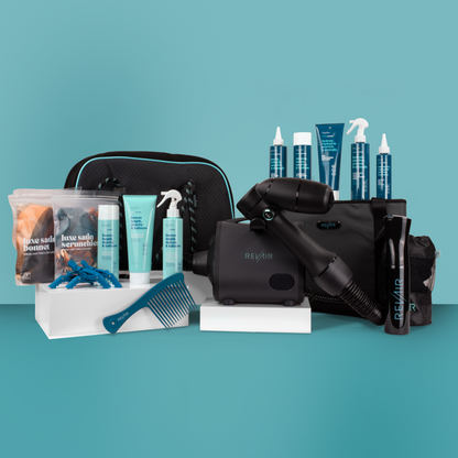 Large collection of RevAir hair care products and accessories surrounding RevAir hair dryer