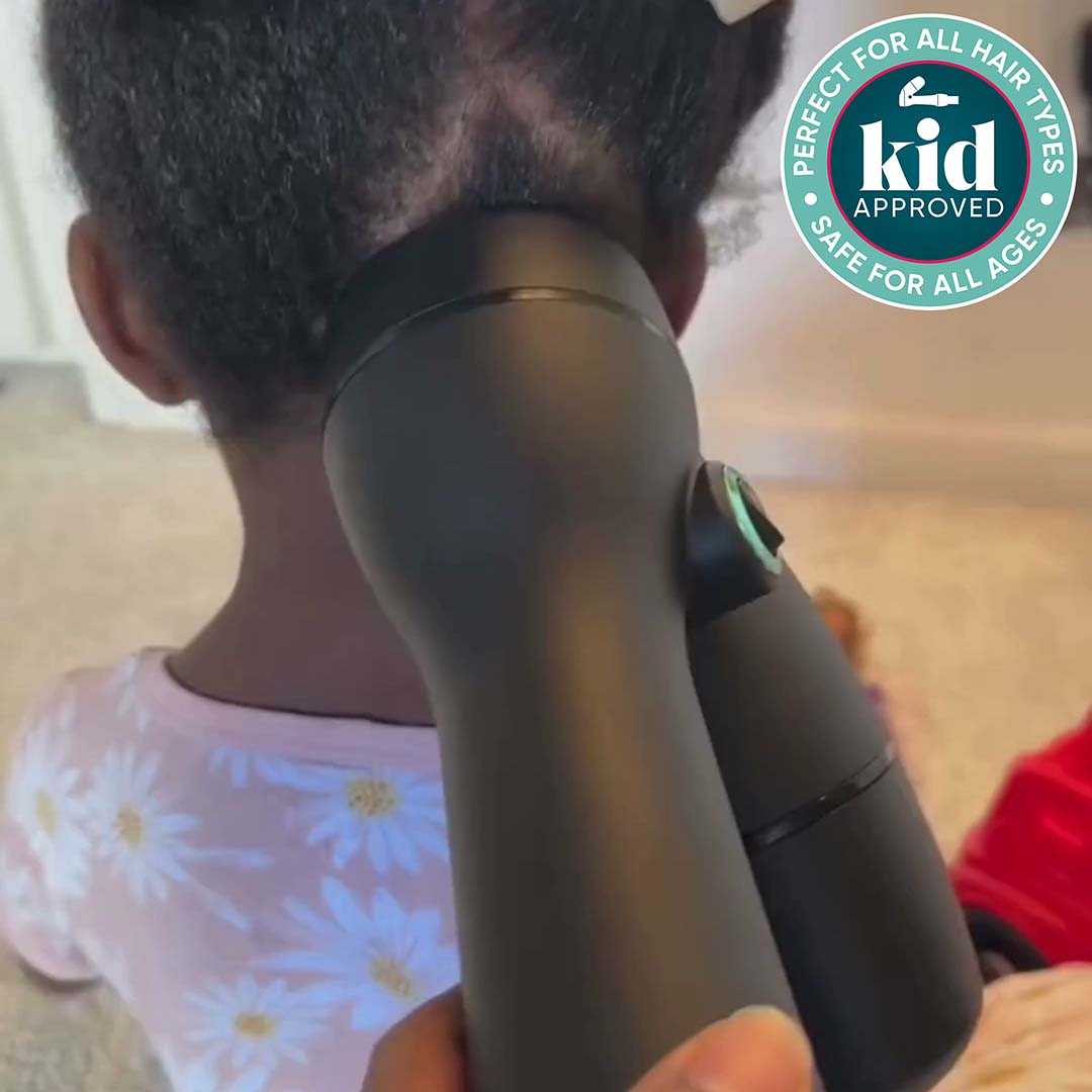 Load video: Mother using a RevAir to dry and stretch a young girl&#39;s hair while she plays with toys. Badge: Kid approved, perfect for all hair types, safe for all ages.